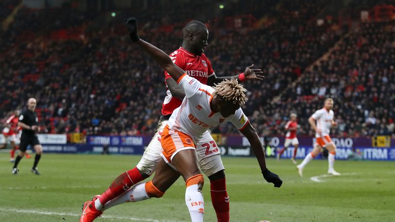 Blackpool's Armand Gnanduillet is challenged by Charlton's Naby Sarr during the Sky Bet League One clash.
