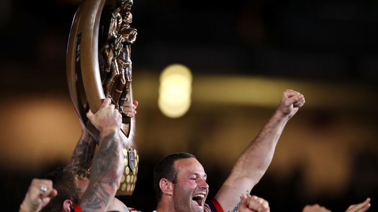 Boyd Cordner of the Roosters holds up the Provan-Summons Trophy as he celebrates victory after the 2018 NRL Grand Final match between the Melbourne Storm and the Sydney Roosters 