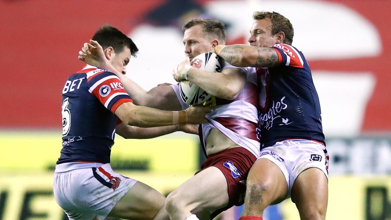 Dan Sarginson is tackled by Sydney Roosters' Jake Friend (right) and Luke Keary