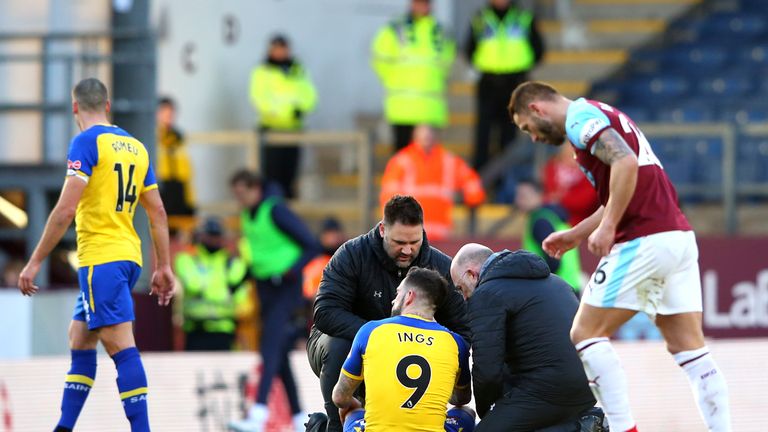 Danny Ings receives treatment after picking up and ankle injury