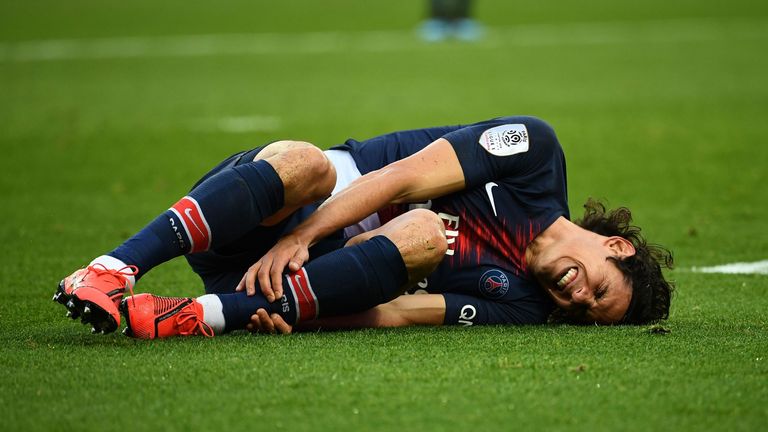 Edinson Cavani lies injured after scoring against Bordeaux