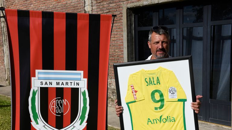Daniel Ribero, President of San Martin Club, poses with Sala's framed jersey at the club where Emiliano Sala's wake took place