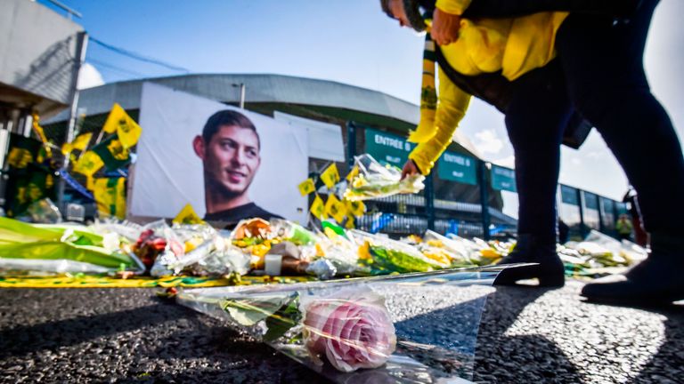A FC Nantes supporter lays flowers in tribute to Emiliano Sala outside the club's the La Beaujoire stadium
