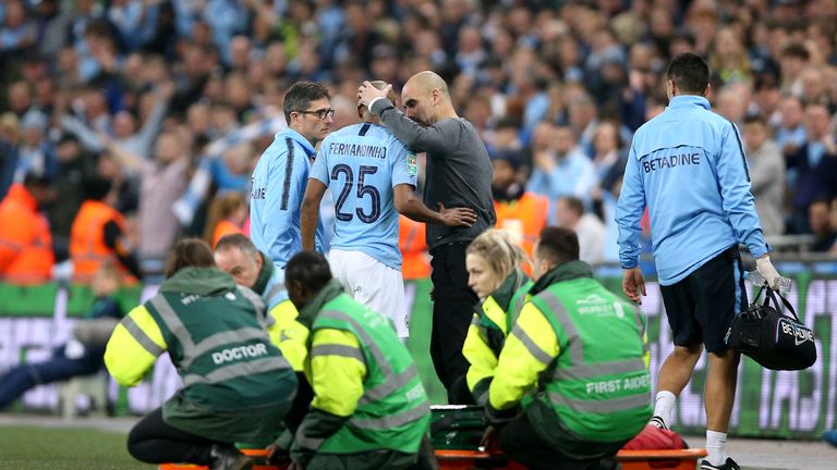 Fernandinho (centre) speaks to Manchester City manager Pep Guardiola as he comes off in the Carabao Cup final