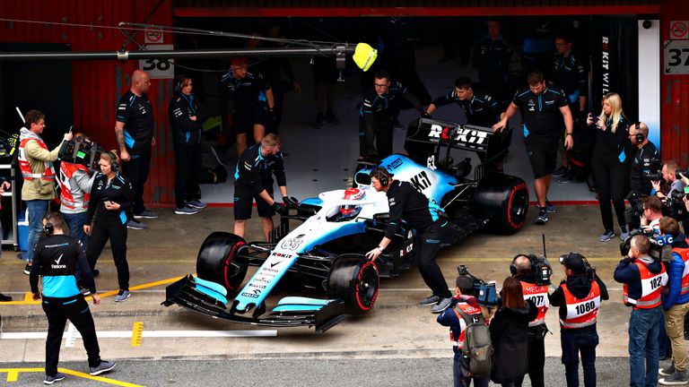 George Russell of Williams is pushed back into the garage on day three of winter testing at Circuit de Catalunya
