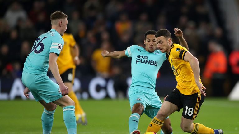 Isaac Hayden and Diogo Jota battle for possession at Molineux