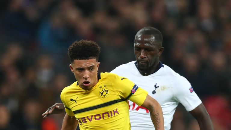 Jadon Sancho is challenged by Moussa Sissoko 