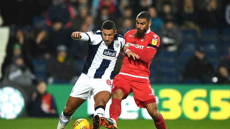 Lewis Grabban and Jake Livermore battle for the ball