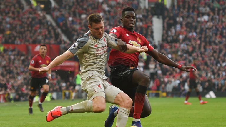 James Milner is challenged by Paul Pogba