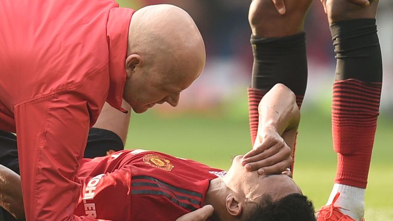 Jesse Lingard receives treatment for an injury during the first-half