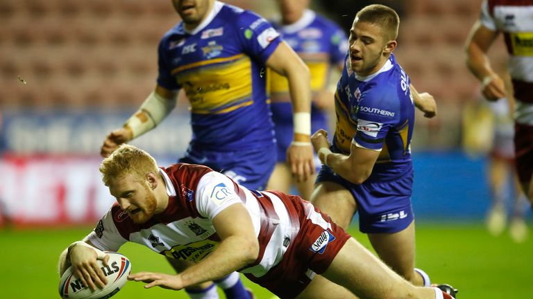 Wigan Warriors' Joe Bullock goes over for a try past Leeds Rhinos' Jack Walker during the Betfred Super League match at the DW Stadium, Wigan. PRESS ASSOCIATION Photo. Picture date: Friday February 8, 2019