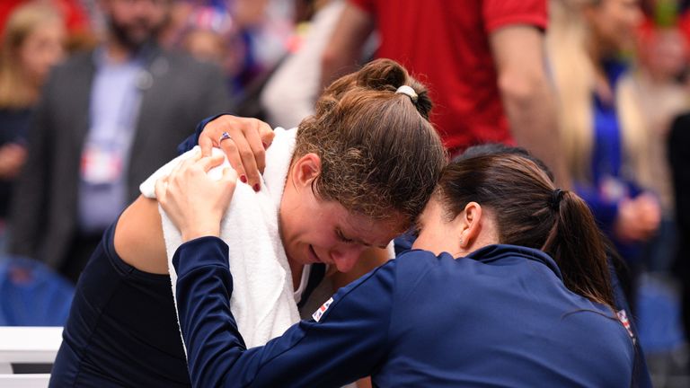 An emotional Johanna Konta of Great Britain(L) is consoled by a member of the coaching staff after winning her match during Day Four of the Fed Cup Europe and Africa Zone Group I at the University of Bath on February 09, 2019 in Bath, England.