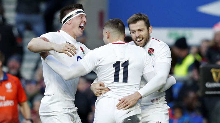 Jonny May (C) celebrates with ETom Curry (L) and  Elliot Daly after scoring his first try against France