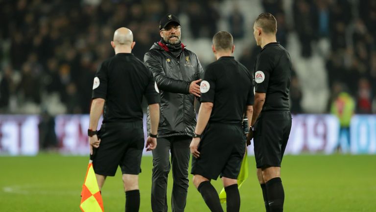Jurgen Klopp approaches referee Kevin Friend and assistant referees Matthew Wilkes and Simon Beck at full-time