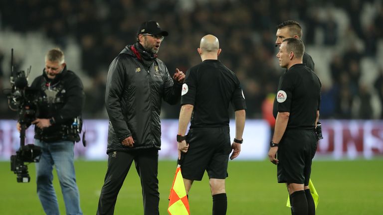 Jurgen Klopp speaks to referee Kevin Friend and assistant referees Matthew Wilkes and Simon Beck following the 1-1 draw with West Ham