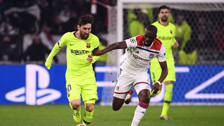 Lionel Messi (L) vies for the ball next to Lyon&#39;s French forward Tanguy NDombele