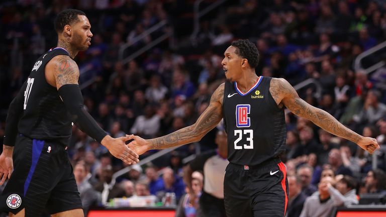 Lou Williams #23 of the LA Clippers celebrates a second half basket with Mike Scott #30 while playing the Detroit Pistons at Little Caesars Arena on February 02, 2019 in Detroit, Michigan. Los Angeles won the game 111-101.