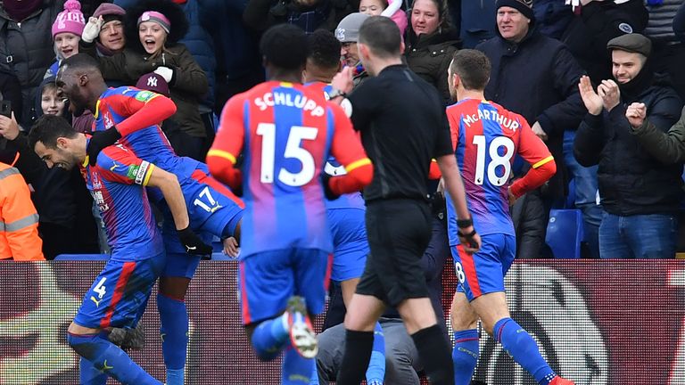 Luka Milivojevic celebrates with teammates after scoring the opening goal