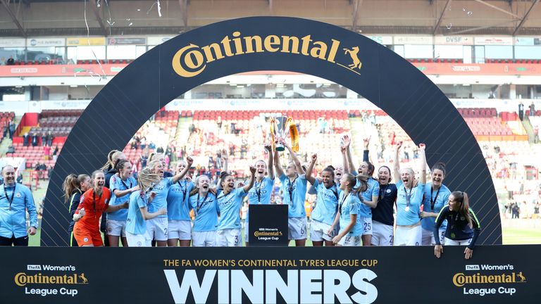 Manchester City celebrate with the trophy