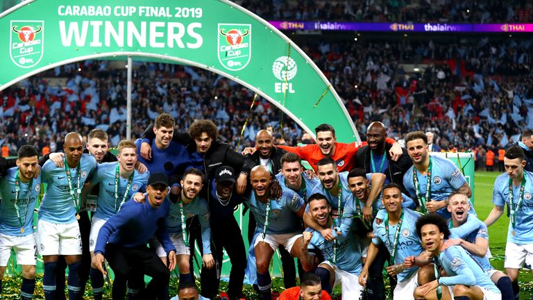 Manchester City players celebrate with the trophy after winning the Carabao Cup Final