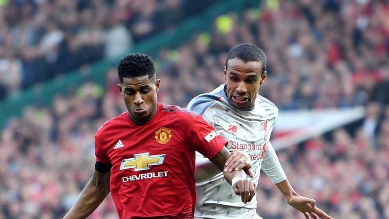 Marcus Rashford and Joel Matip compete for possession