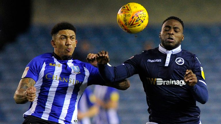 Liam Palmer of Sheffield Wednesday battles for possession with Fred Onyedinma of Millwall during the Sky Bet Championship match between Millwall and Sheffield Wednesday at The Den on February 12, 2019 in London, England. 