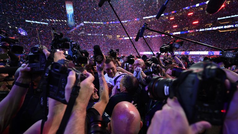 Head Coach Bill Belichick of the New England Patriots (C-R) and quarterback for the New England Patriots Tom Brady (C) are surrounded by journalists as they celebrtes after winning Super Bowl LIII against the Los Angeles Rams at Mercedes-Benz Stadium in Atlanta, Georgia, on February 3, 2019.