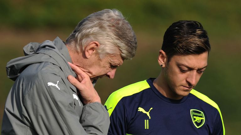 Arsenal manager Arsene Wenger talks with Mesut Ozil during a training session at London Colney on October 31, 2016 in St Albans, England. 
