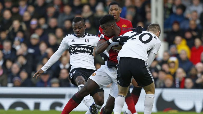 Paul Pogba vies with Jean Michael Seri (L) and Maxime Le Marchand