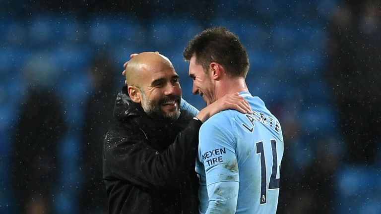 Josep Guardiola, Manager of Manchester City and Aymeric Laporte of Manchester City celebrate victory after the Premier League match between Manchester City and West Bromwich Albion at Etihad Stadium on January 31, 2018 in Manchester, England.