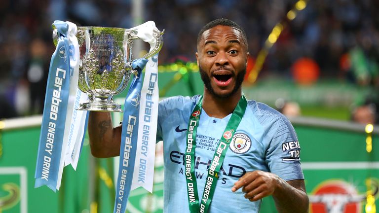 Raheem Sterling celebrates with the trophy after Manchester City's defeat of Chelsea in the Carabao Cup Final at Wembley Stadium
