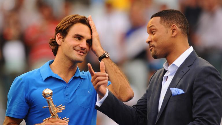 Will Smith congratulates Roger Federer of Switzerland after his victory over Tomas Berdych of Czech Republic in the Men's Single Final on Day Nine of the Mutua Madrilena Madrid Open at the Caja Magica on May 13, 2012 in Madrid, Spain