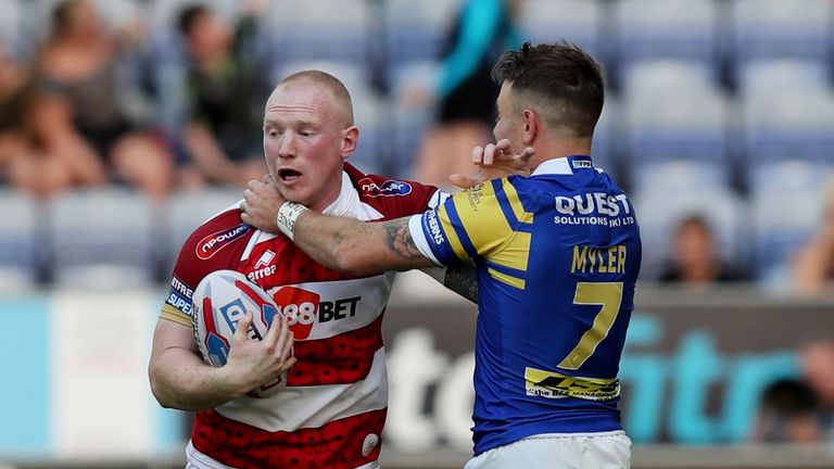  Wigan Warriors' Liam Farrell fends off Leeds Rhinos' Richie Myler