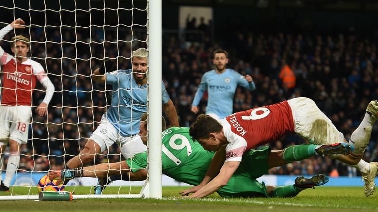 Sergio Aguero squeezes the ball over the line for his hat-trick