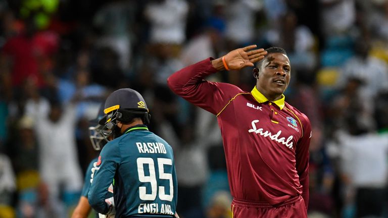 Sheldon Cottrell (R) of West Indies celebrates the dismissal of Adil Rashid (L) of England during the 2nd ODI between West Indies and England at Kensington Oval, Bridgetown, Barbados, on February 22, 2019.