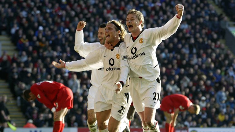 Solskjaer celebrates with Diego Forlan after his goal at Anfield