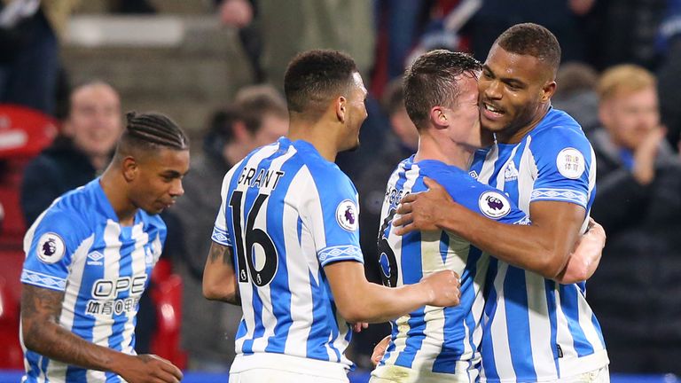 Steve Mounie celebrates with team-mates after scoring Huddersfield's injury-time winner