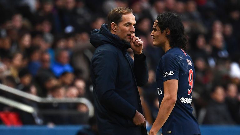 Thomas Tuchel confers with a dejected Edinson Cavani as he limps off the pitch