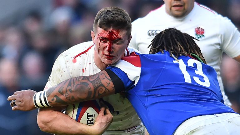 A bloody Tom Curry is tackled by France&#39;s Mathieu Bastareaud