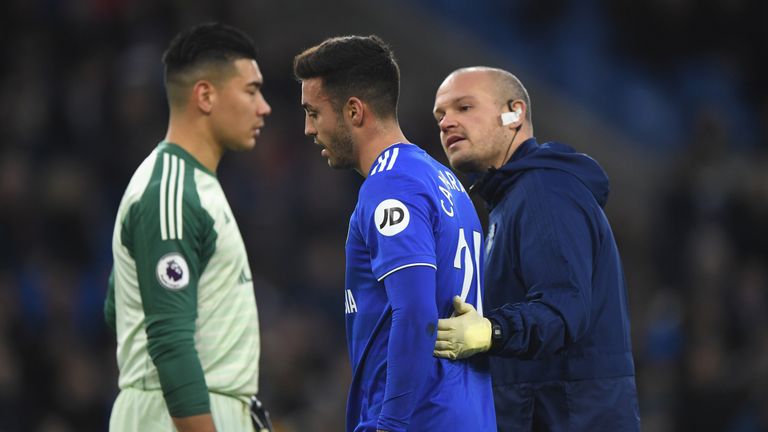 Injured Cardiff player Victor Camarasa is led from the field as Neil Etheridge looks on during the Premier League match between Cardiff City and Huddersfield Town at Cardiff City Stadium on January 12, 2019 in Cardiff, United Kingdom.