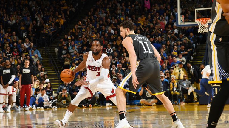 Dwyane Wade of the Miami Heat handles the ball during the game against Klay Thompson of the Golden State Warriors