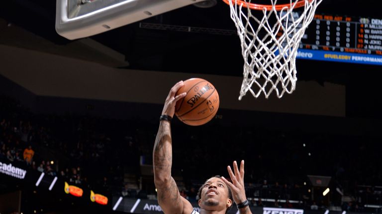 DeMar DeRozan finishes at the rim against Denver