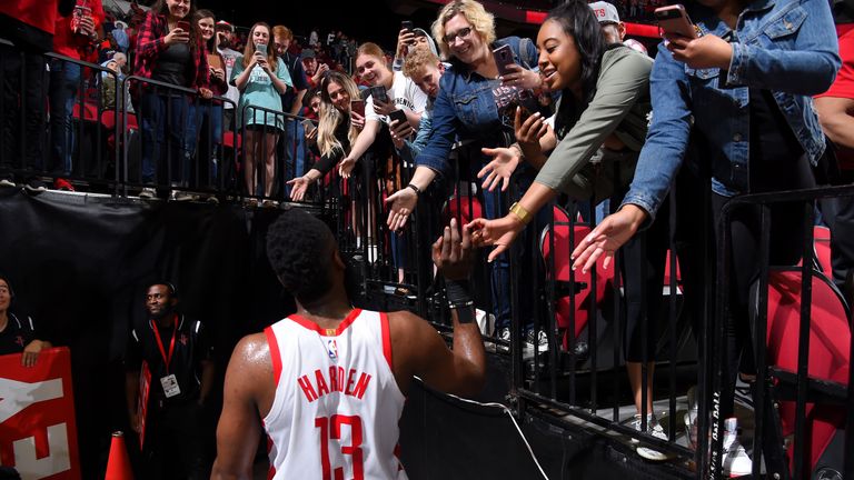 James Harden hi-fives fans after the game against the Sacramento Kings