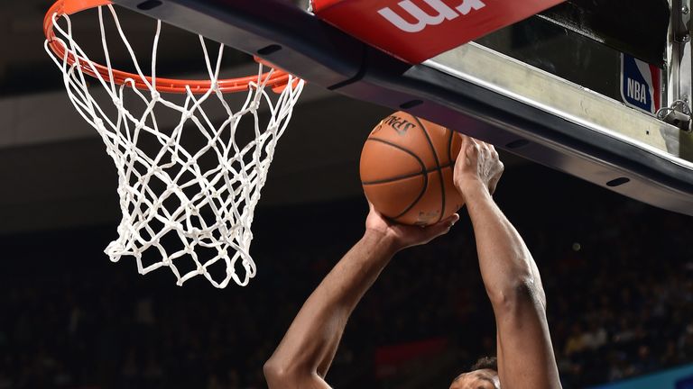 Joel Embiid scores at the rim against Cleveland