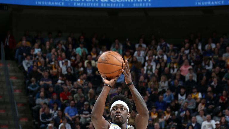 Jrue Holiday fires a jump shot against Utah