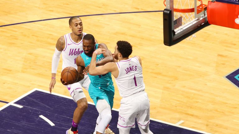 Kemba Walker absorbs contact while attacking the basket against Charlotte