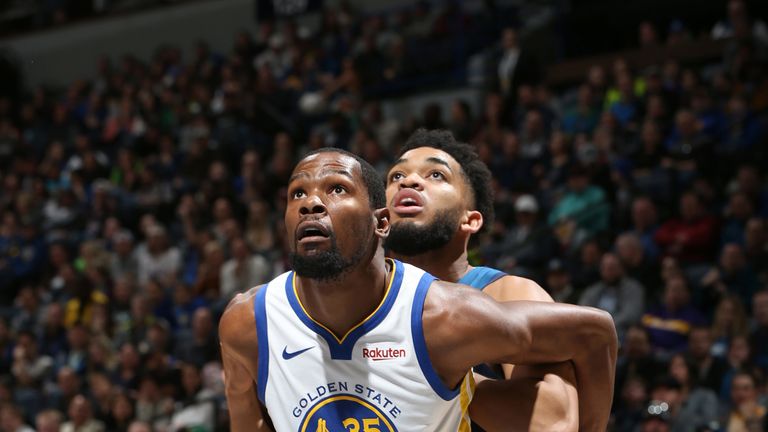 Kevin Durant and Karl-Anthony Towns compete for a rebound