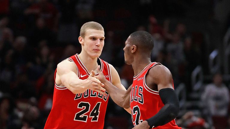 Kris Dunn congratulates Bulls team-mate Lauri Markkanen