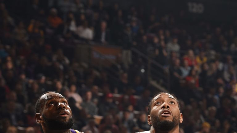 LeBron James and Kawhi Leonard battle for a rebound