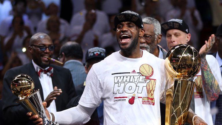 LeBron James celebrates winning the NBA title, along with Finals MVP, with the Miami Heat